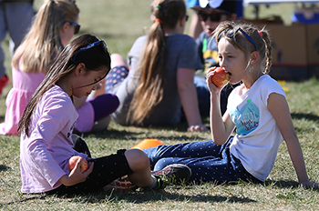 Girls snacking at the Ormsby School YRC run, June 2019