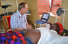 Dr. Ray Comeau with a patient in Kenya