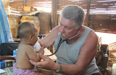 Dr. Myron Semkuley tends a patient at the SAW orphanage