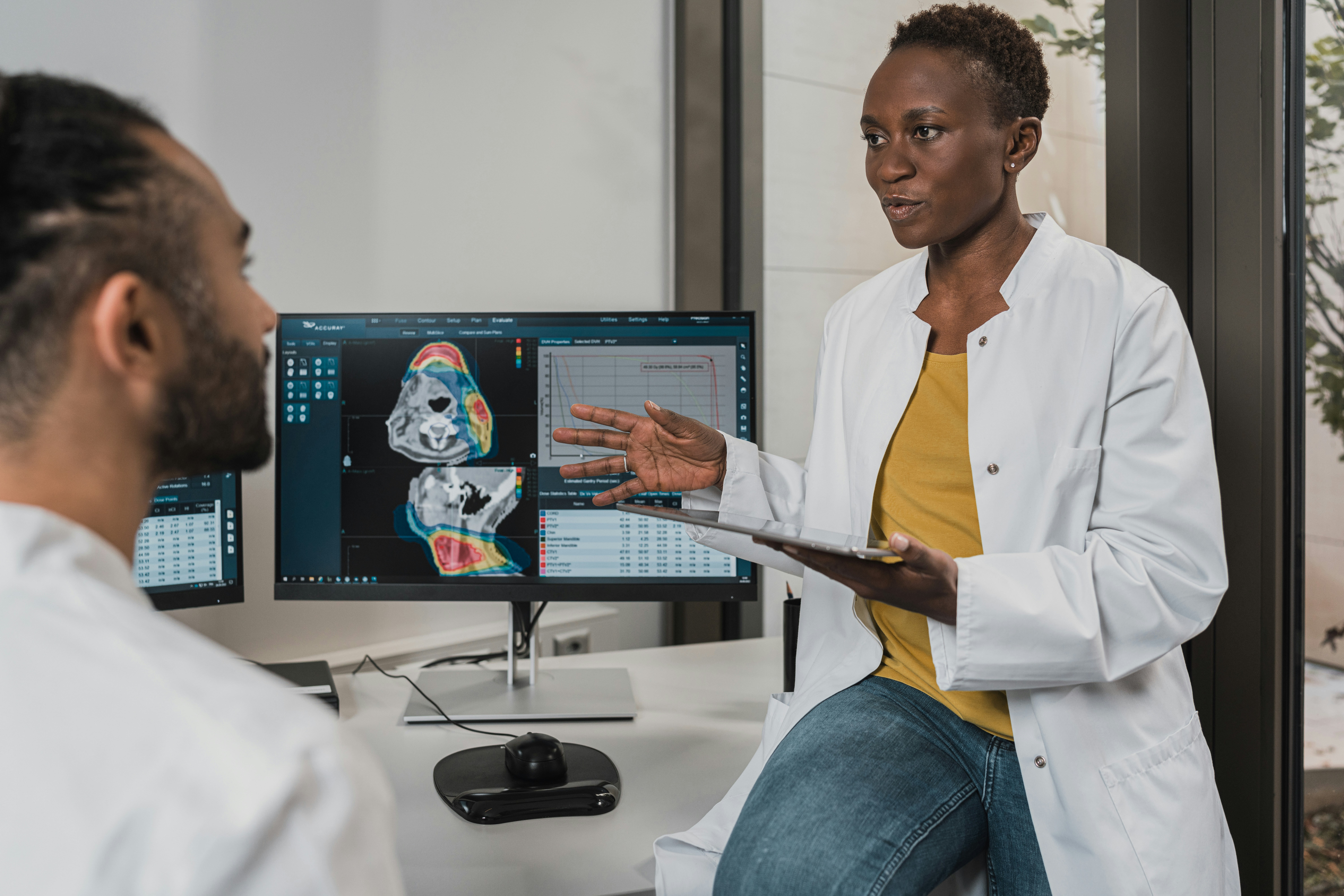 Doctors sitting at computer talking